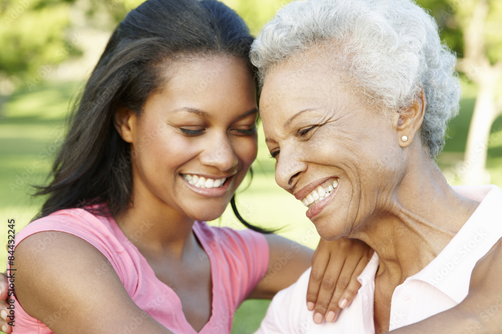 African American Mother And Adult Daughter Relaxing In Park African American Mother And Adult Daughter Relaxing In Park