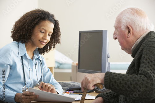 Young female Doctor with senior male patient photo
