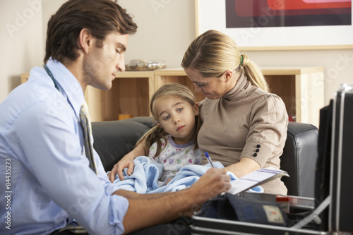 Doctor visiting sick child and mother at home photo