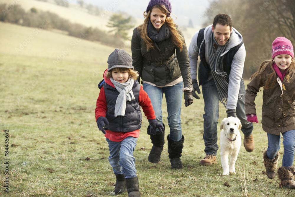 Family and dog having fun in the country in winter