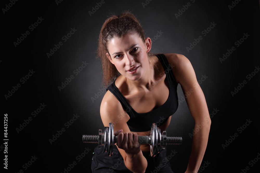 beautiful sporty  woman working out with dumbbells