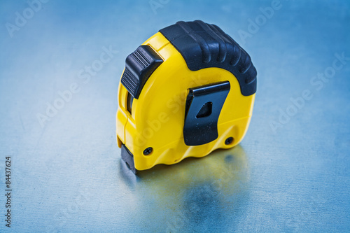 Plastic measuring tape on metallic background construction conce