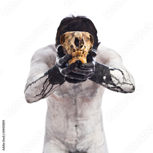 Primitive man offering a rabbit skull