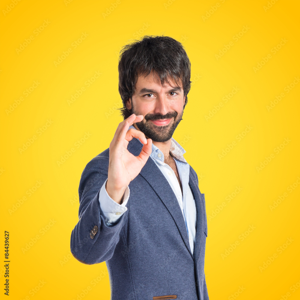 Businessman making Ok sign over white background Businessman making Ok sign over white background