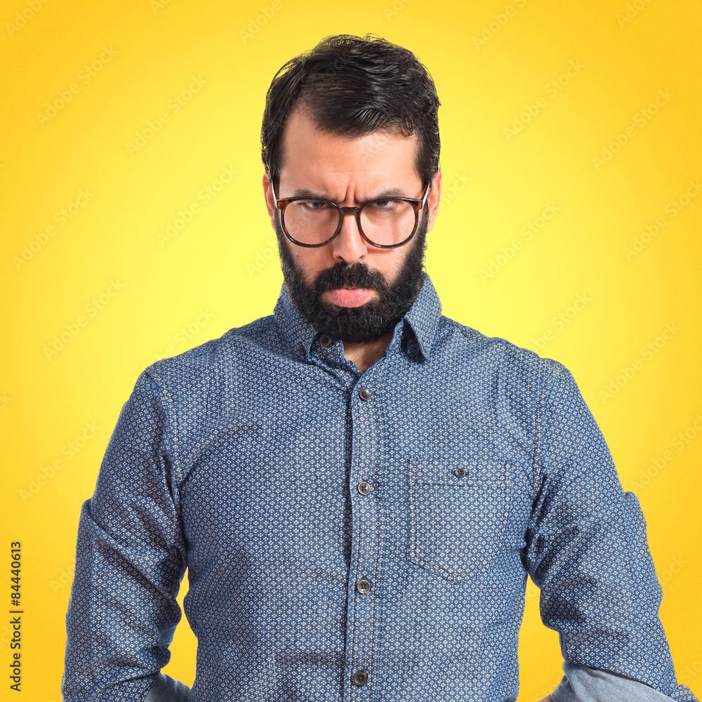Fototapeta premium Sad hipster man over isolated white background