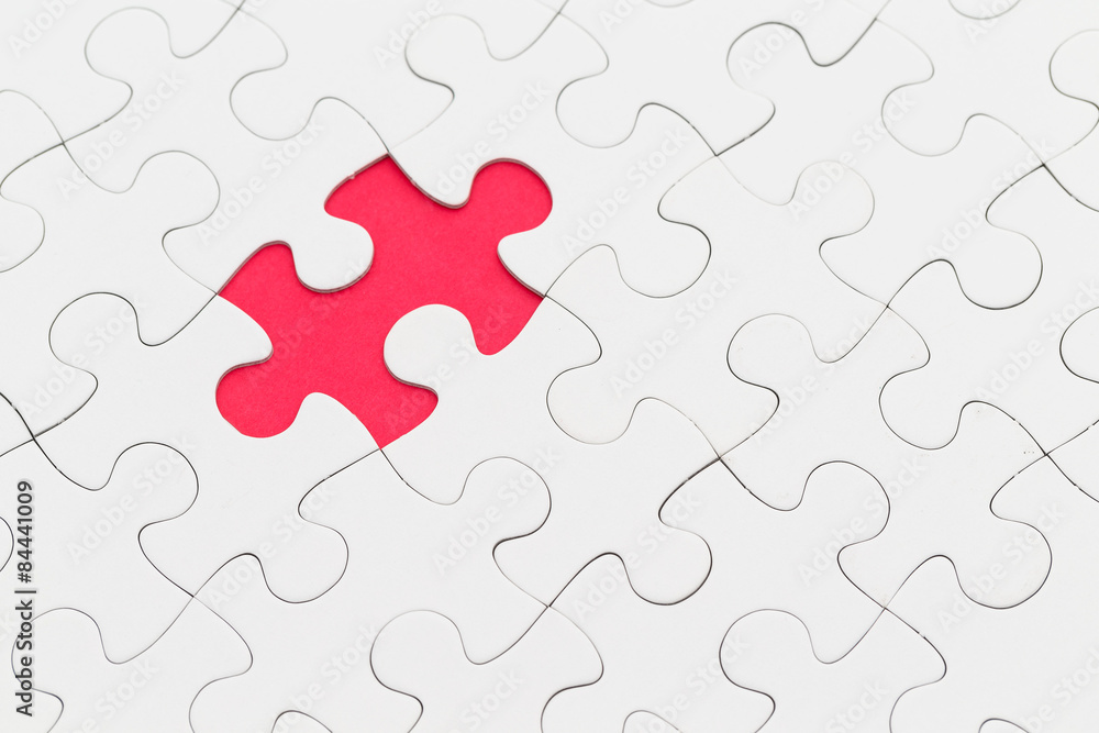 Fototapeta premium Puzzle with missing piece over red background