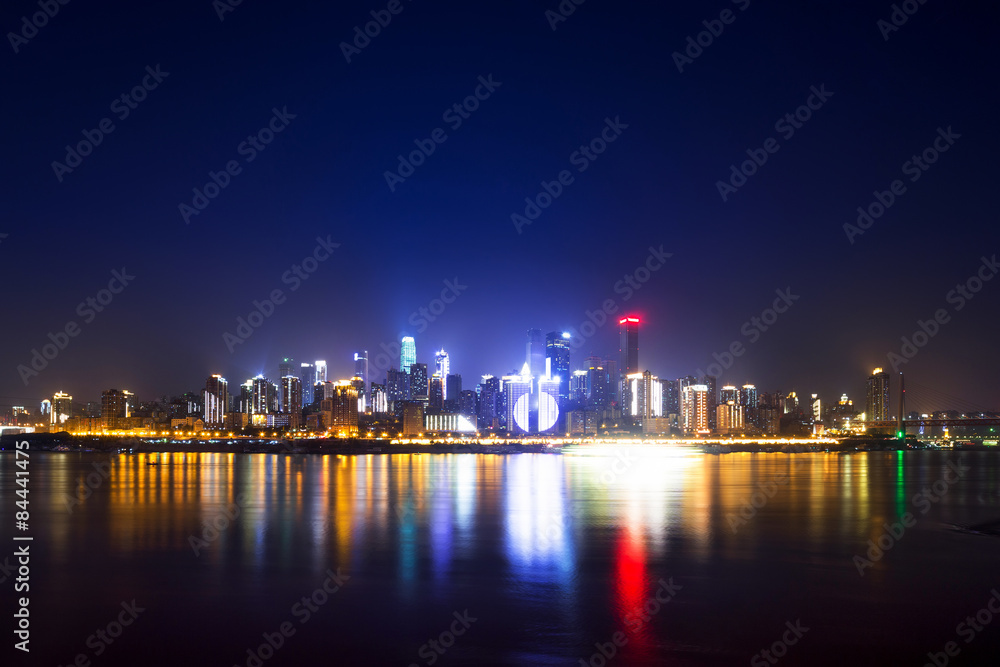 illuminated skyline of chongqing at riverbank