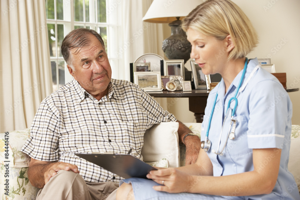 Obraz premium Retired Senior Man Having Health Check With Nurse At Home