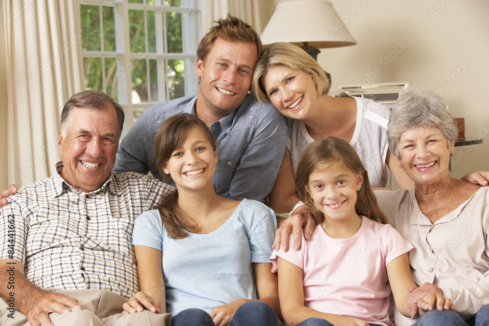 Multi Generation Family Group Sitting On Sofa Indoors Multi Generation Family Group Sitting On Sofa Indoors