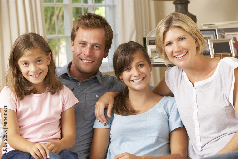 Family Group Sitting On Sofa Indoors Family Group Sitting On Sofa Indoors