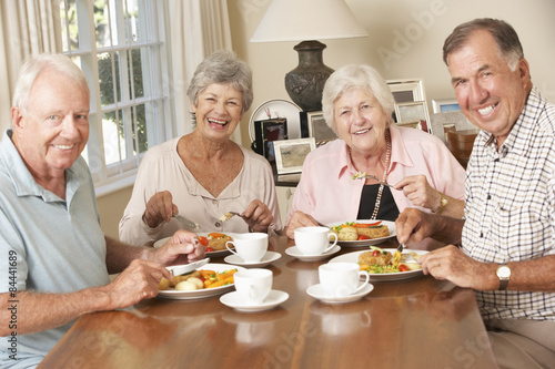 Group Of Senior Couples Enjoying Meal Together