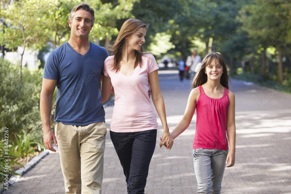Family Walking Through Summer Park