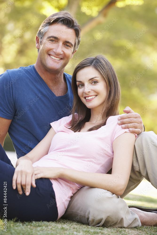 Romantic Couple Sitting On Grass In Summer Park Romantic Couple Sitting On Grass In Summer Park