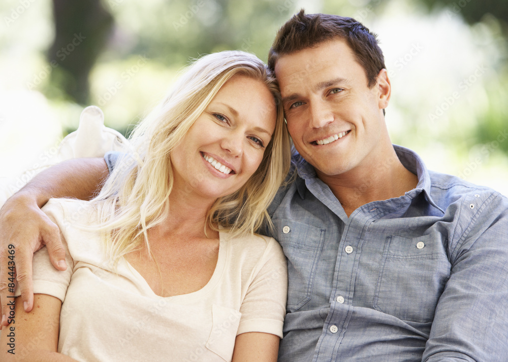 Couple Relaxing On Sofa At Home Couple Relaxing On Sofa At Home