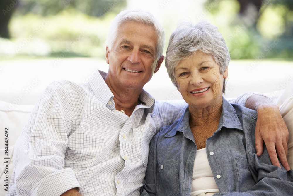 Senior Couple Relaxing On Sofa At Home