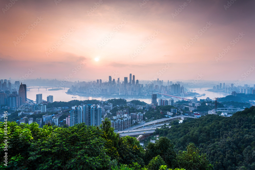 skyline and landscape of chongqing at riverbank during sunrise.