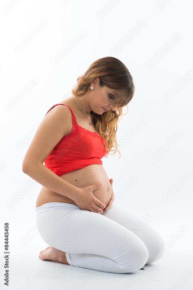 Pregnant woman look down sitting white bg Pregnant woman look down sitting white bg
