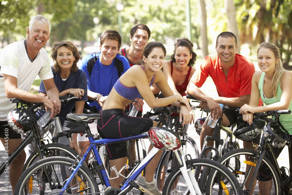 Group Of Cyclists Resting During Cycle Ride Through Park Group Of Cyclists Resting During Cycle Ride Through Park