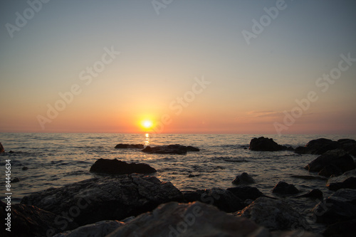 Sunset over the sea among the rocks 