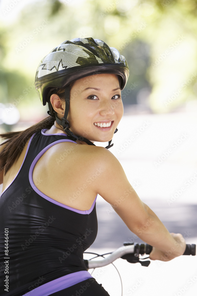 Woman Cycling Through Park Woman Cycling Through Park