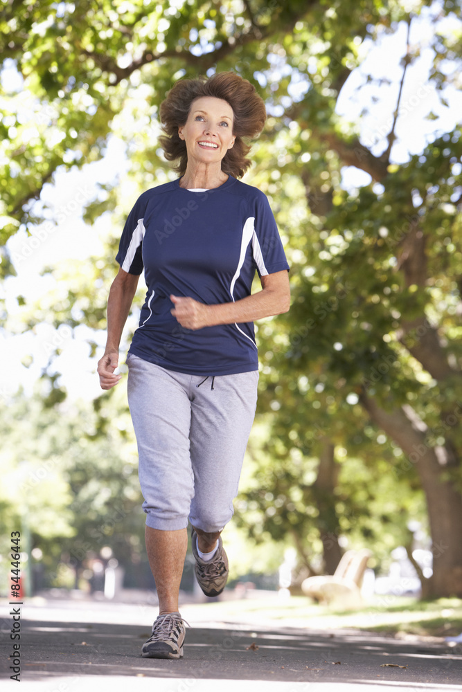 Senior Woman Running Through Park Senior Woman Running Through Park