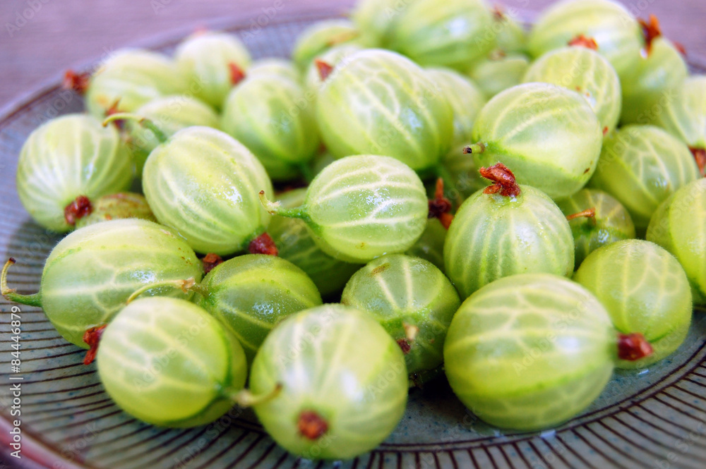fresh fruits background with gooseberries on rustic wooden table fresh fruits background with gooseberries on rustic wooden table