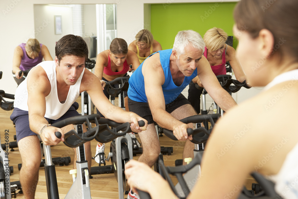 Group Taking Part In Spinning Class In Gym Group Taking Part In Spinning Class In Gym