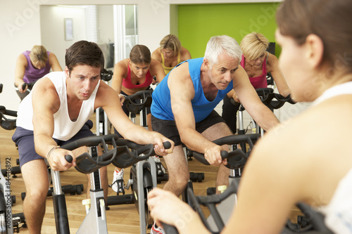 Group Taking Part In Spinning Class In Gym