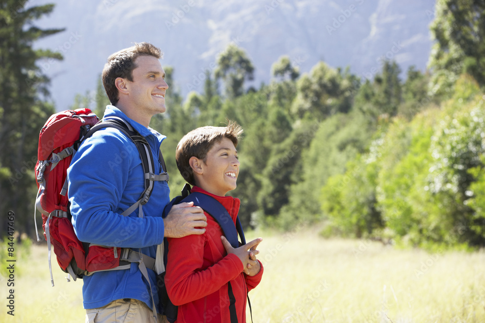 Father And Son On Hike In Beautiful Countryside Father And Son On Hike In Beautiful Countryside