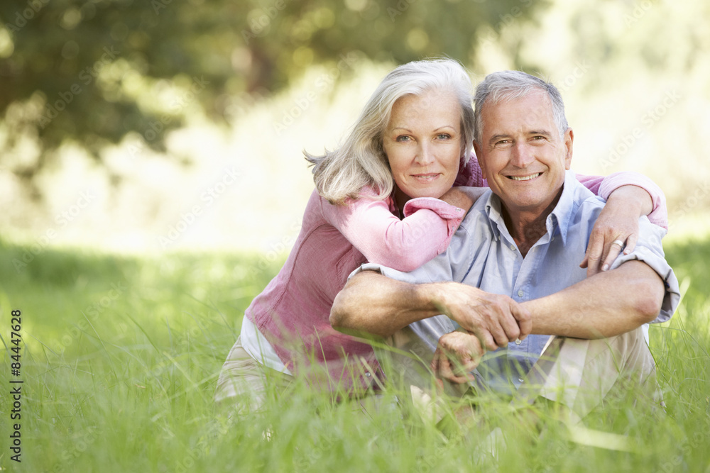 Fototapeta premium Senior Couple Relaxing In Sunny Summer Field
