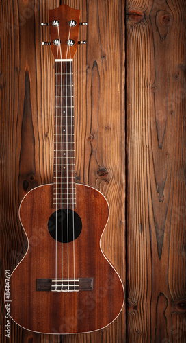 ukulele on wooden background photo