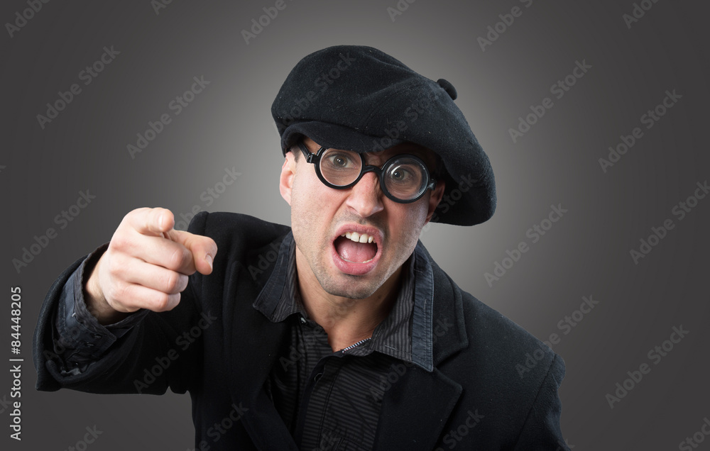 Angry man in a beret pointing at camera Angry man in a beret pointing at camera