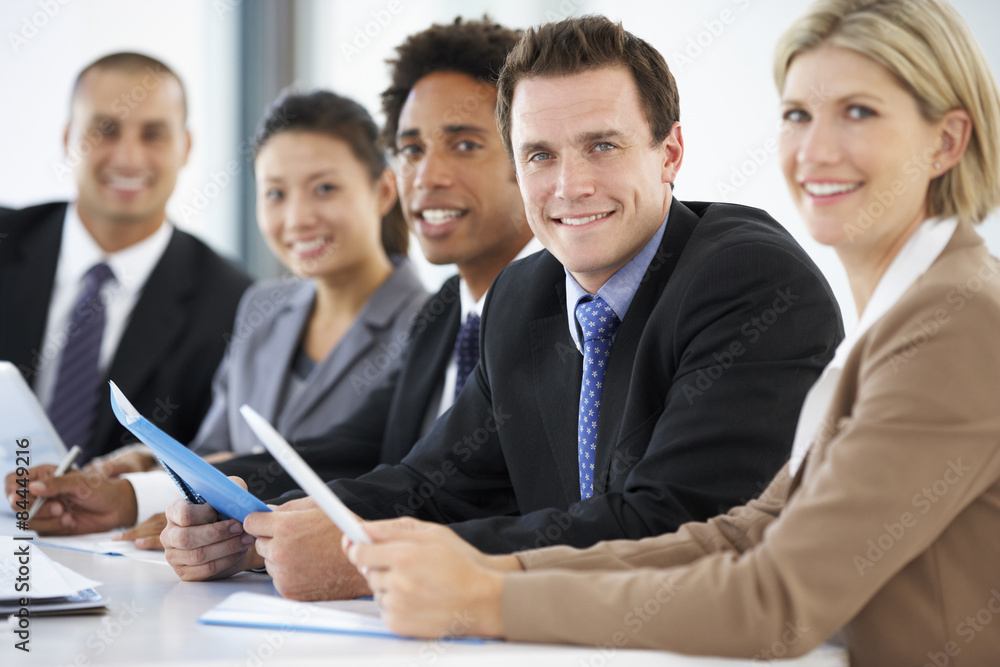 Portrait Of Male Executive Attending Office Meeting With Colleagues Portrait Of Male Executive Attending Office Meeting With Colleagues