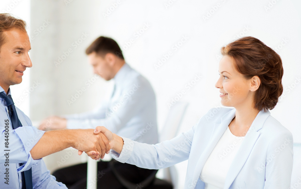 Fototapeta premium man and woman shaking hands in office