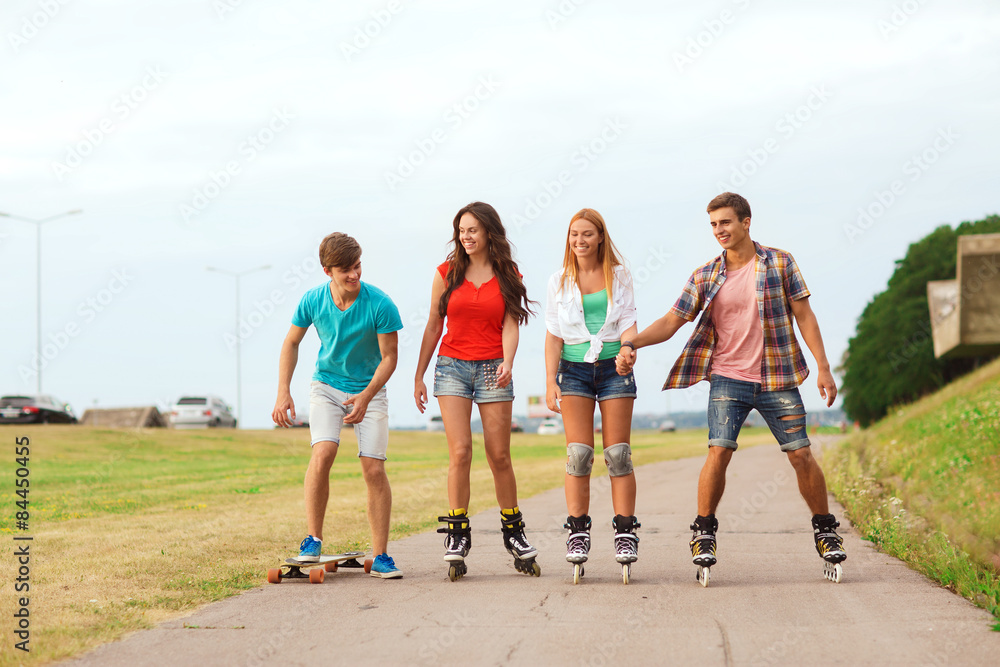 group of smiling teenagers with roller-skates group of smiling teenagers with roller-skates