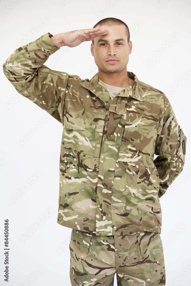Studio Portrait Of Soldier Wearing Uniform And Saluting Studio Portrait Of Soldier Wearing Uniform And Saluting