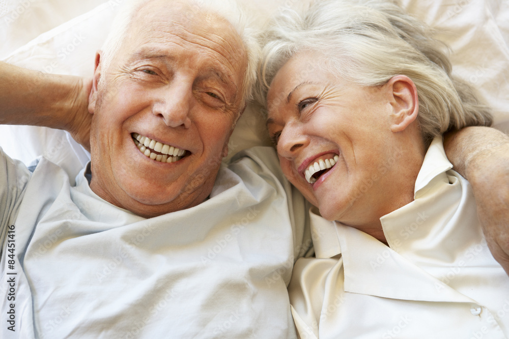 Senior Couple Relaxing In Bed Senior Couple Relaxing In Bed