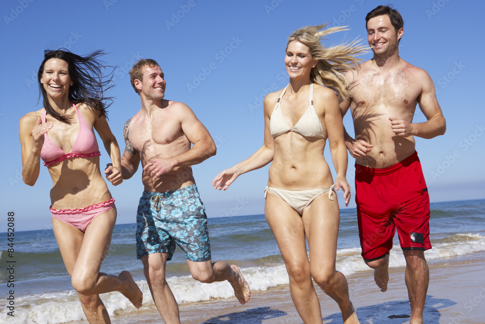 Group Of Friends Having Fun On Beach Holiday Together Group Of Friends Having Fun On Beach Holiday Together