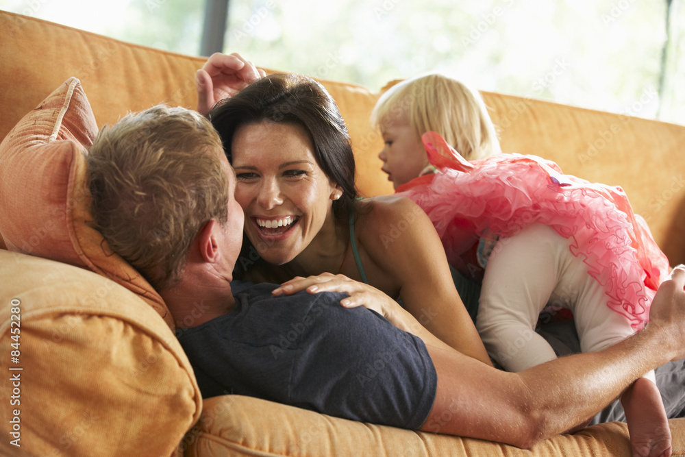 Family Lying On Sofa At Home Family Lying On Sofa At Home