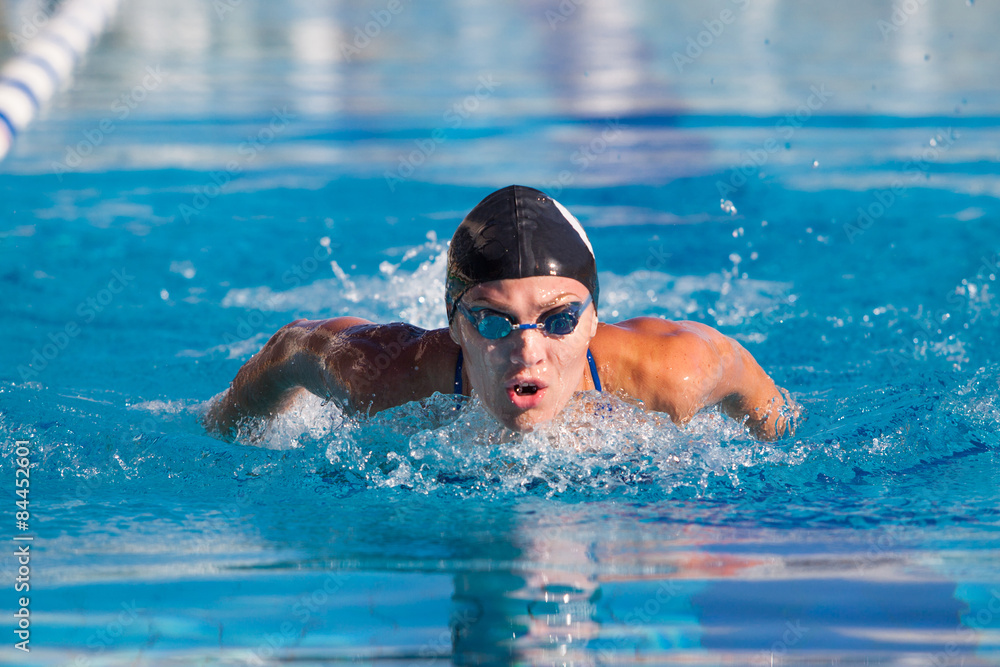 Butterfly swimmer in cap and glasses  the pool