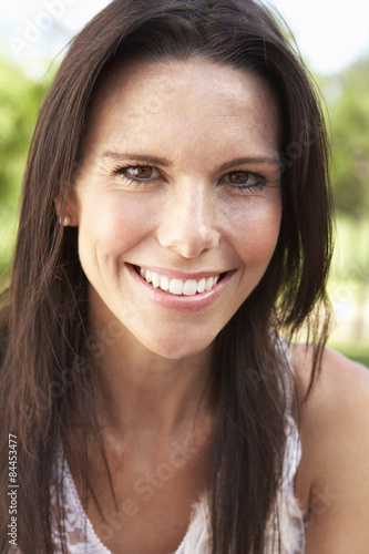 Head And Shoulders Portrait Of Smiling Woman