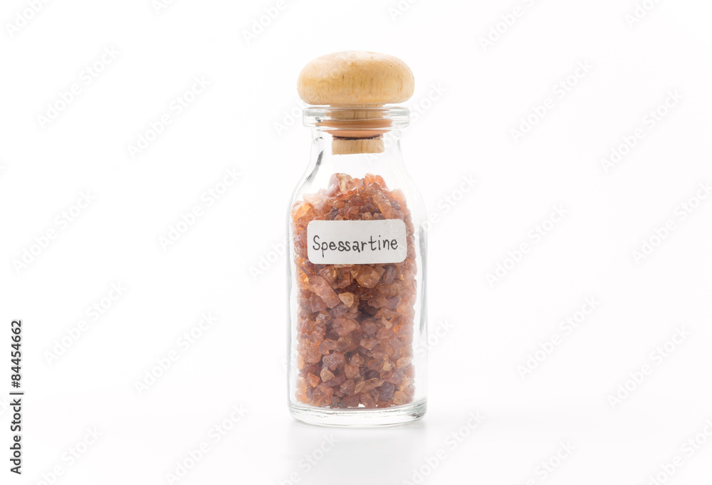 spessartine in glass bottle isolated spessartine in glass bottle isolated
