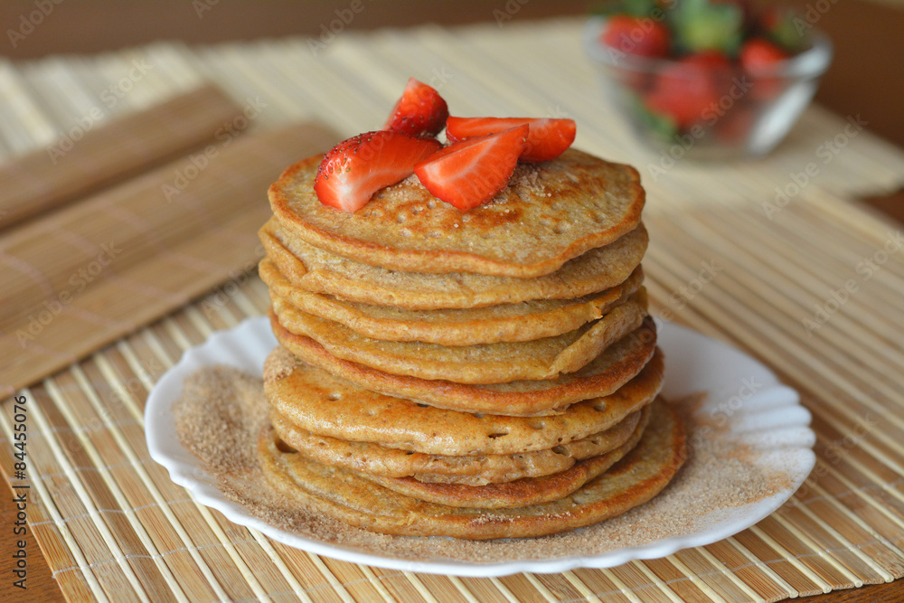 Stack of sweet pancakes with fresh strawberries and cinnamon sugar Stack of sweet pancakes with fresh strawberries and cinnamon sugar