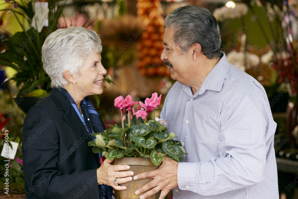 Senior Man Buying Plant As Gift For Wife