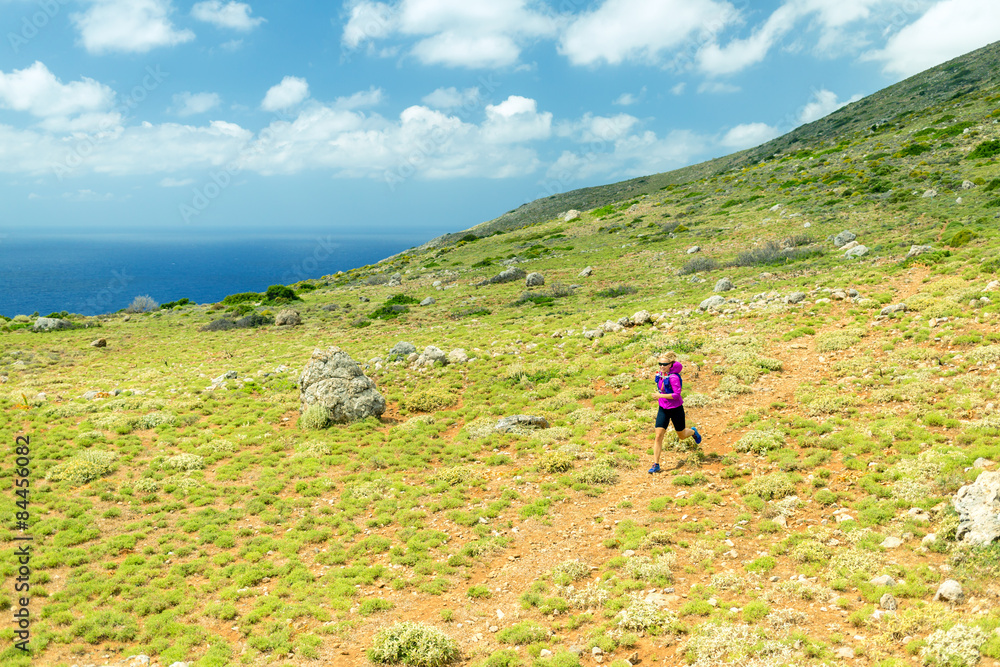 Happy woman trail running in beautiful mountains Happy woman trail running in beautiful mountains