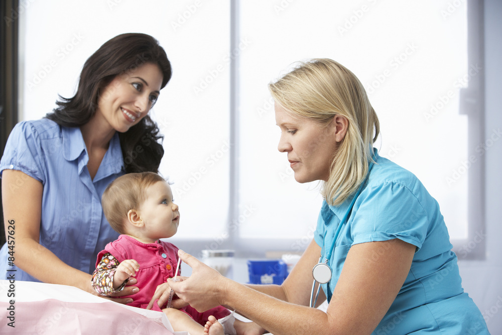 Doctor In Surgery Giving Baby Girl Injection Doctor In Surgery Giving Baby Girl Injection