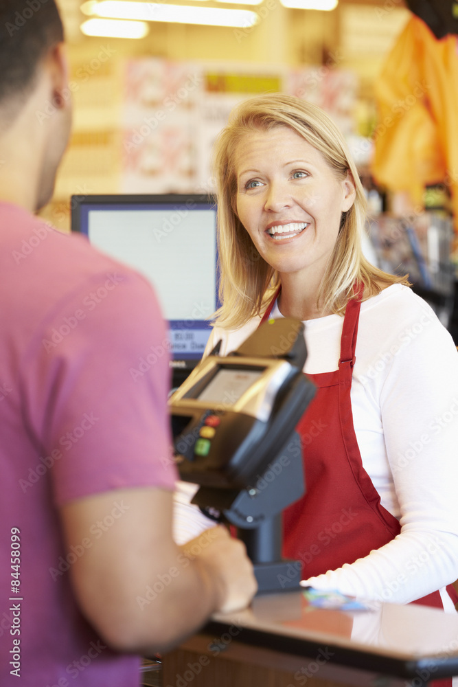 Customer Paying For Shopping At Supermarket Checkout Customer Paying For Shopping At Supermarket Checkout
