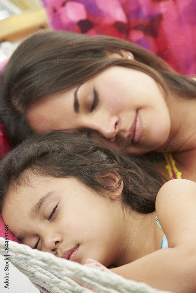 Mother And Daughter Sleeping In Garden Hammock Together Mother And Daughter Sleeping In Garden Hammock Together
