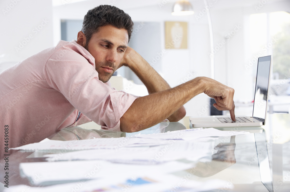 Stressed Man Working At Laptop In Home Office Stressed Man Working At Laptop In Home Office