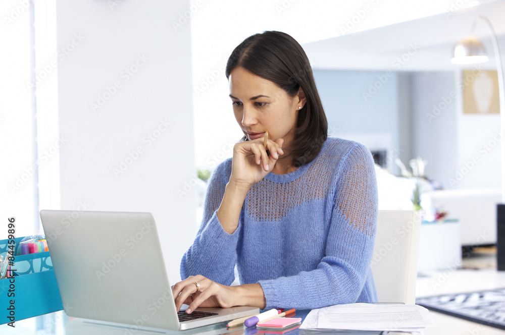 Woman Working At Laptop In Home Office Woman Working At Laptop In Home Office